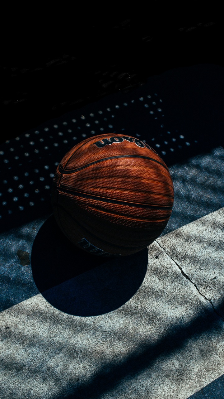 Brown Basketball on Black and White Textile. Wallpaper in 720x1280 Resolution