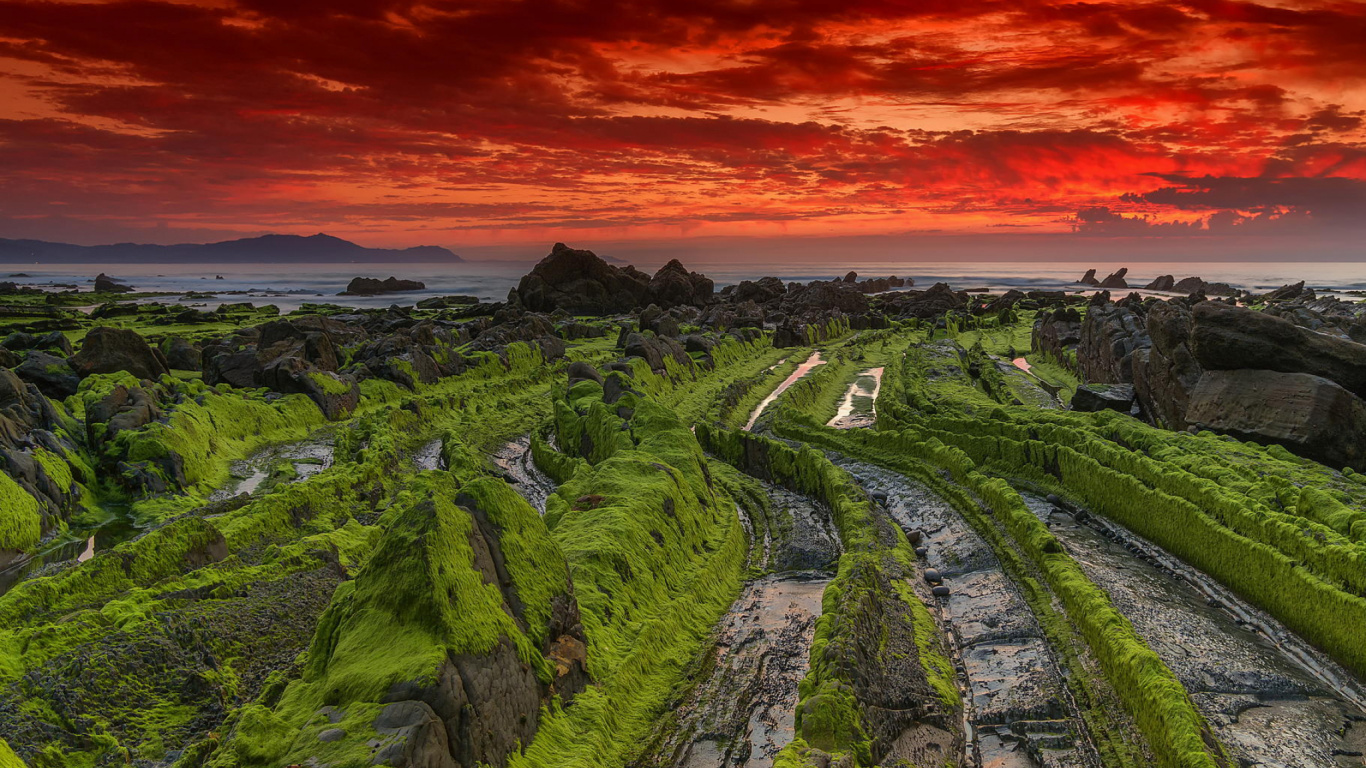 Green Mountain Under Orange Sky. Wallpaper in 1366x768 Resolution