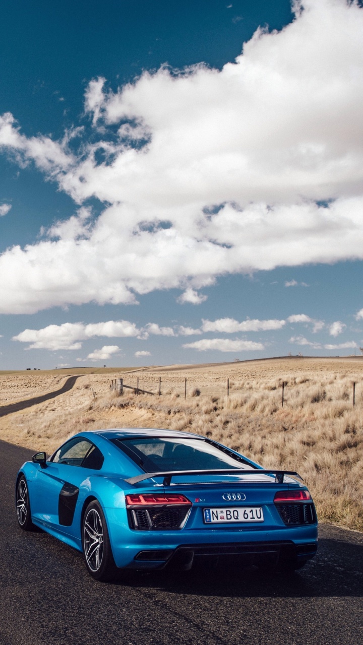 Blue Audi r 8 Auf Braunem Feld Unter Blau-weiß Bewölktem Himmel Tagsüber. Wallpaper in 720x1280 Resolution