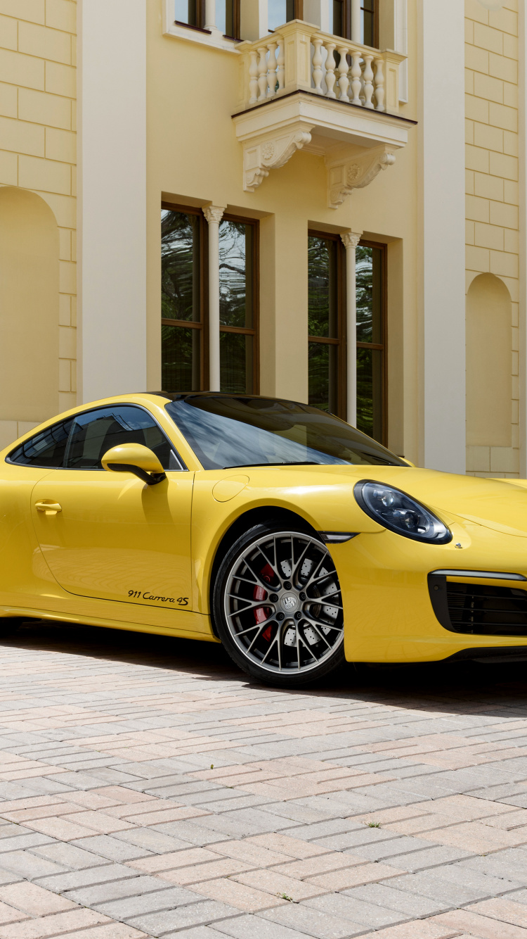 Gelber Lamborghini Aventador Vor Weißem Gebäude Geparkt. Wallpaper in 750x1334 Resolution