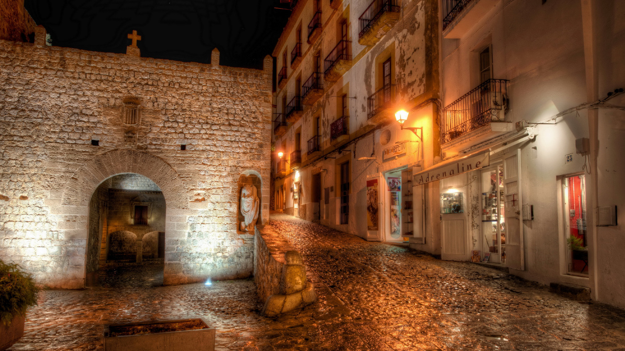 Brown Brick Building With Water Fountain During Night Time. Wallpaper in 1280x720 Resolution