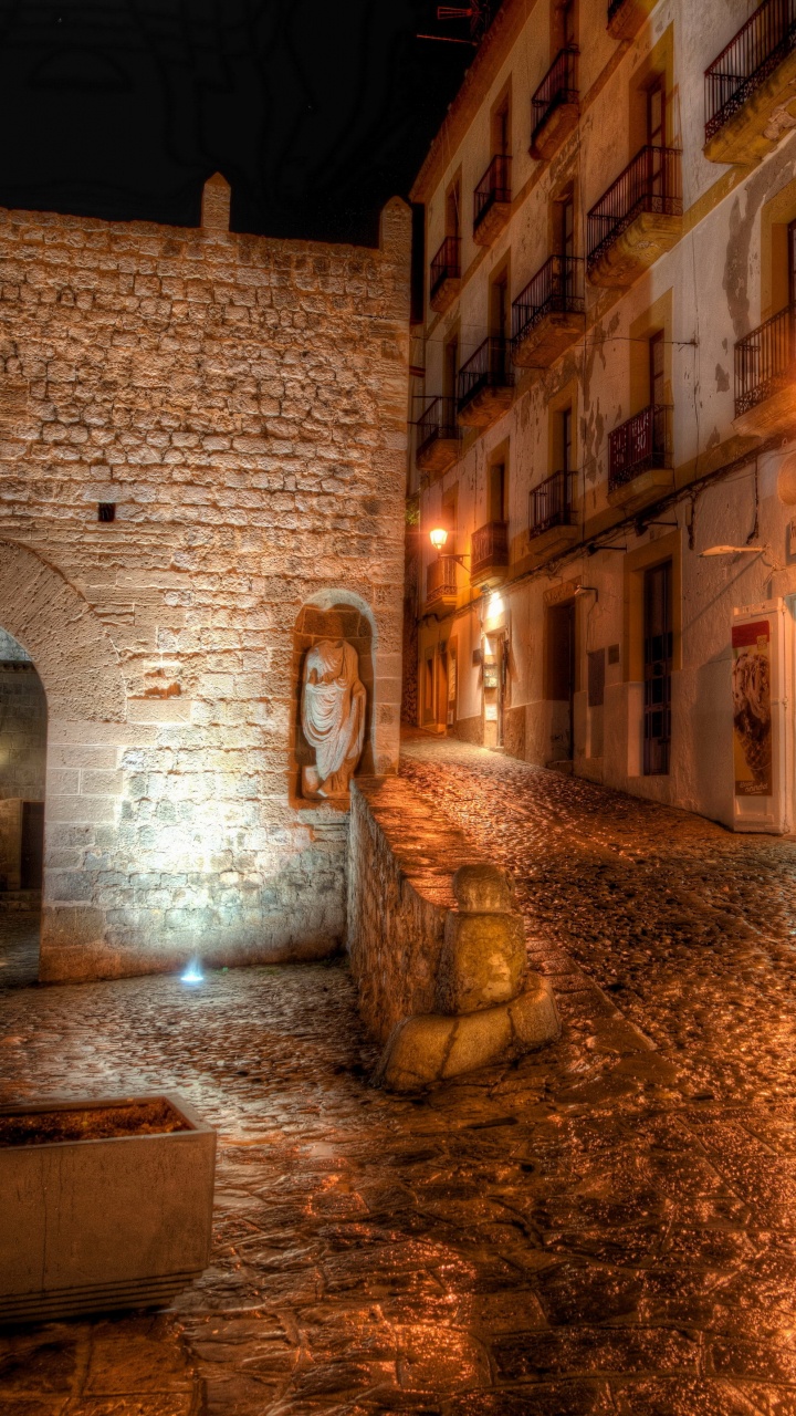 Brown Brick Building With Water Fountain During Night Time. Wallpaper in 720x1280 Resolution