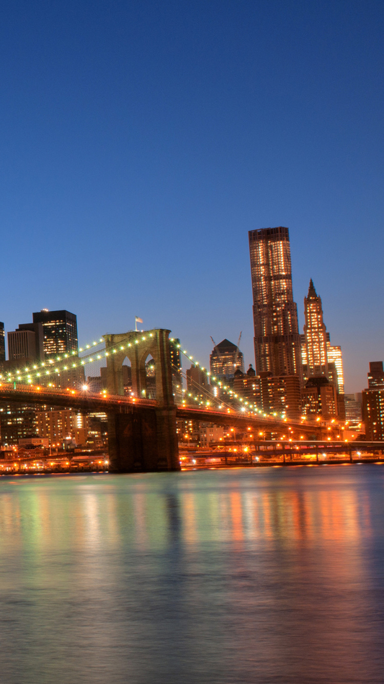 Lighted Bridge Over Water During Night Time. Wallpaper in 750x1334 Resolution