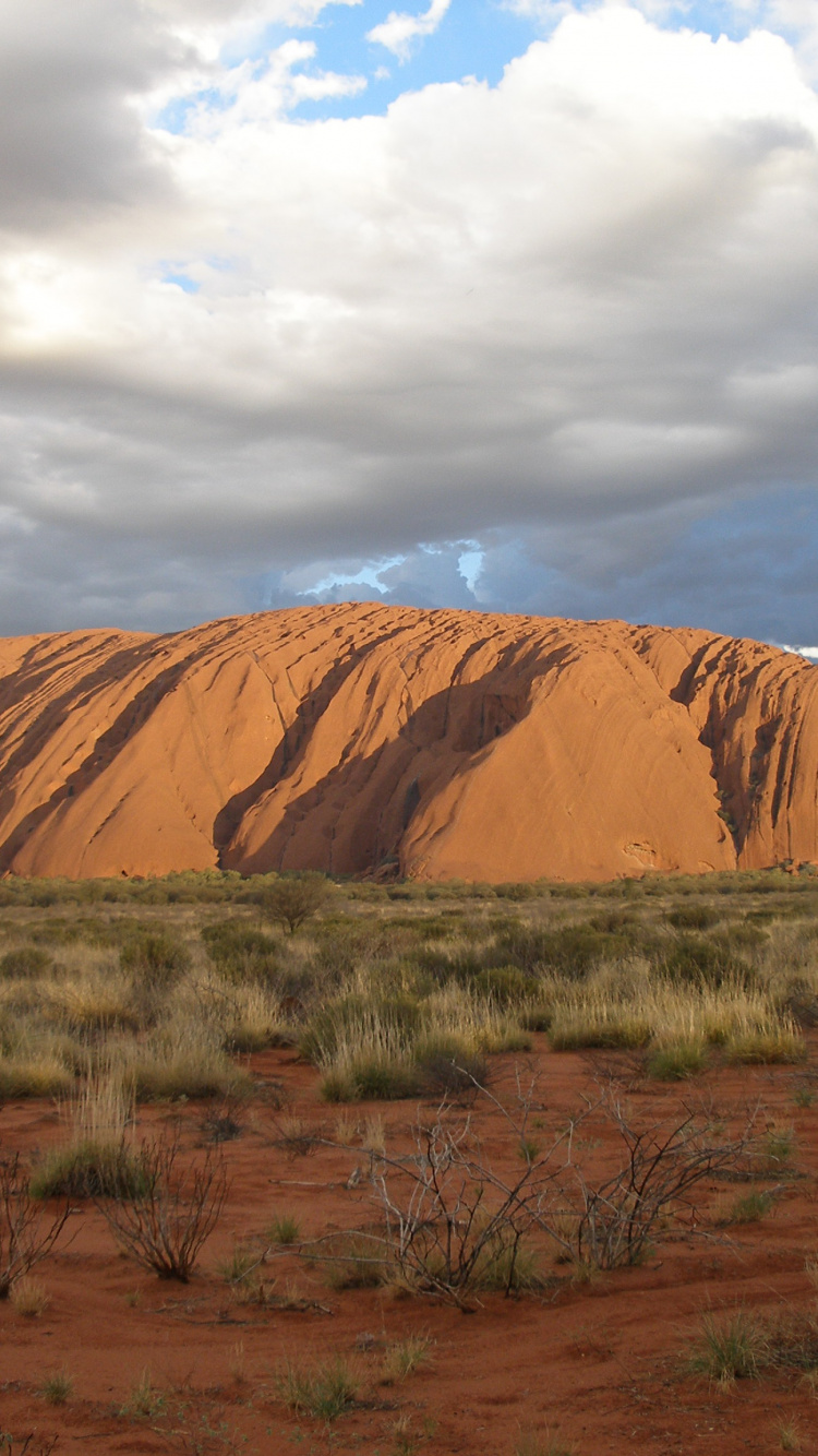 Brown Mountain Under White Clouds During Daytime. Wallpaper in 750x1334 Resolution