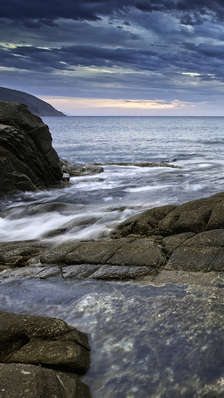 Brown Rock Formation on Sea Under Blue Sky During Daytime. Wallpaper in 720x1280 Resolution