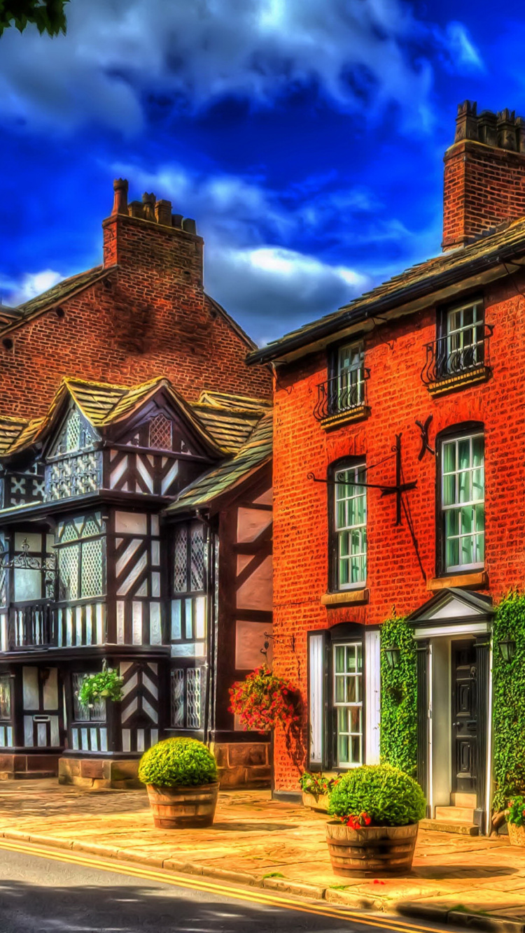 Brown Brick Building Under Blue Sky. Wallpaper in 750x1334 Resolution