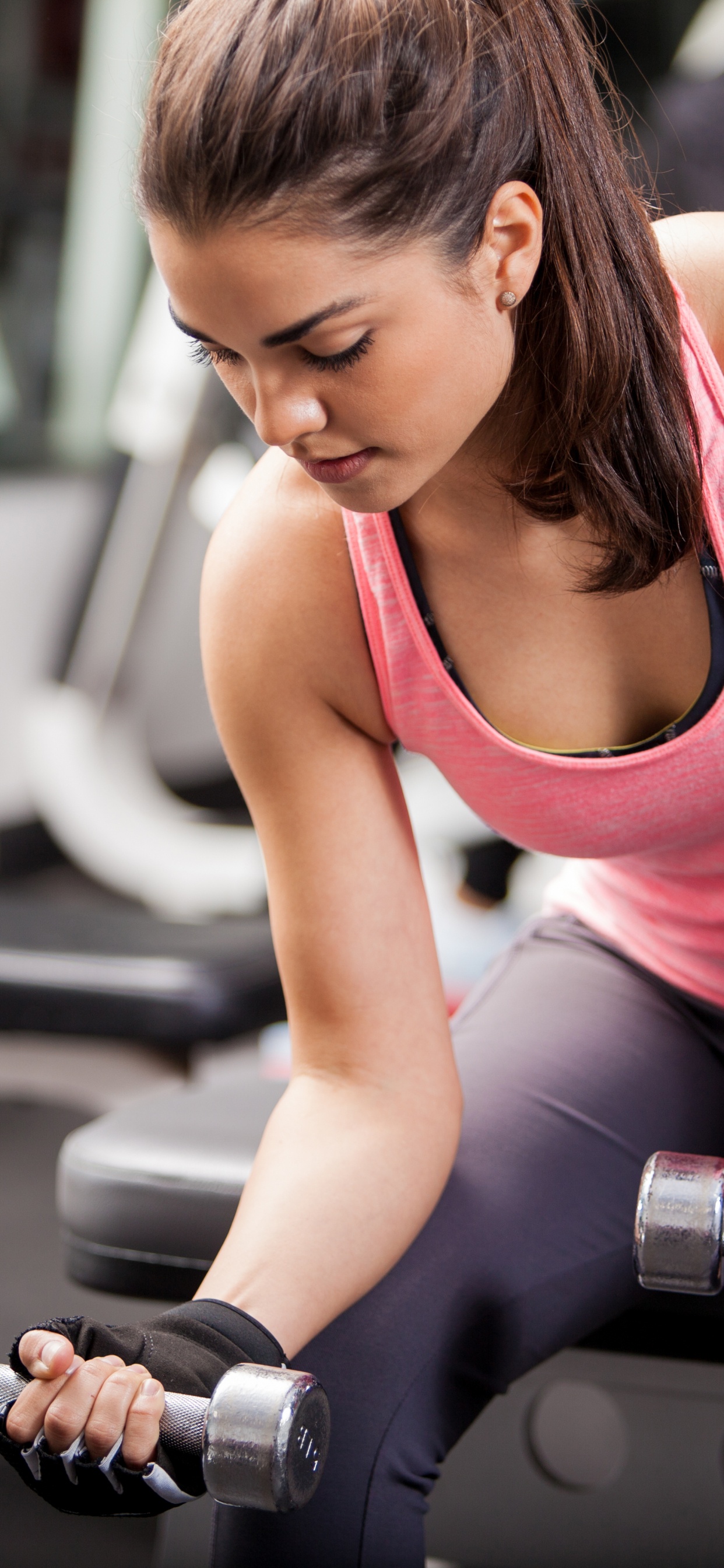 Woman in Pink Tank Top Holding Dumbbell. Wallpaper in 1242x2688 Resolution