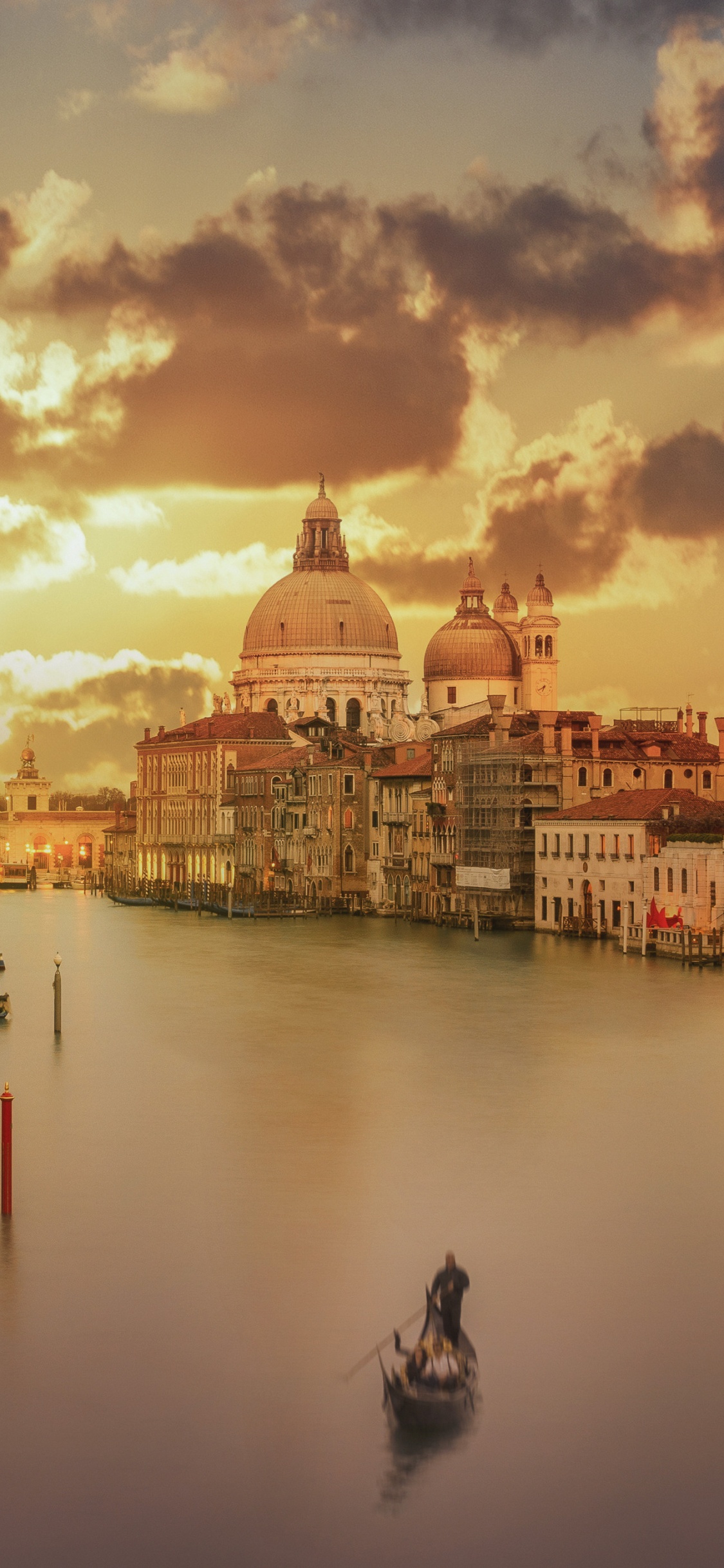 Boat on Water Near Buildings During Sunset. Wallpaper in 1125x2436 Resolution