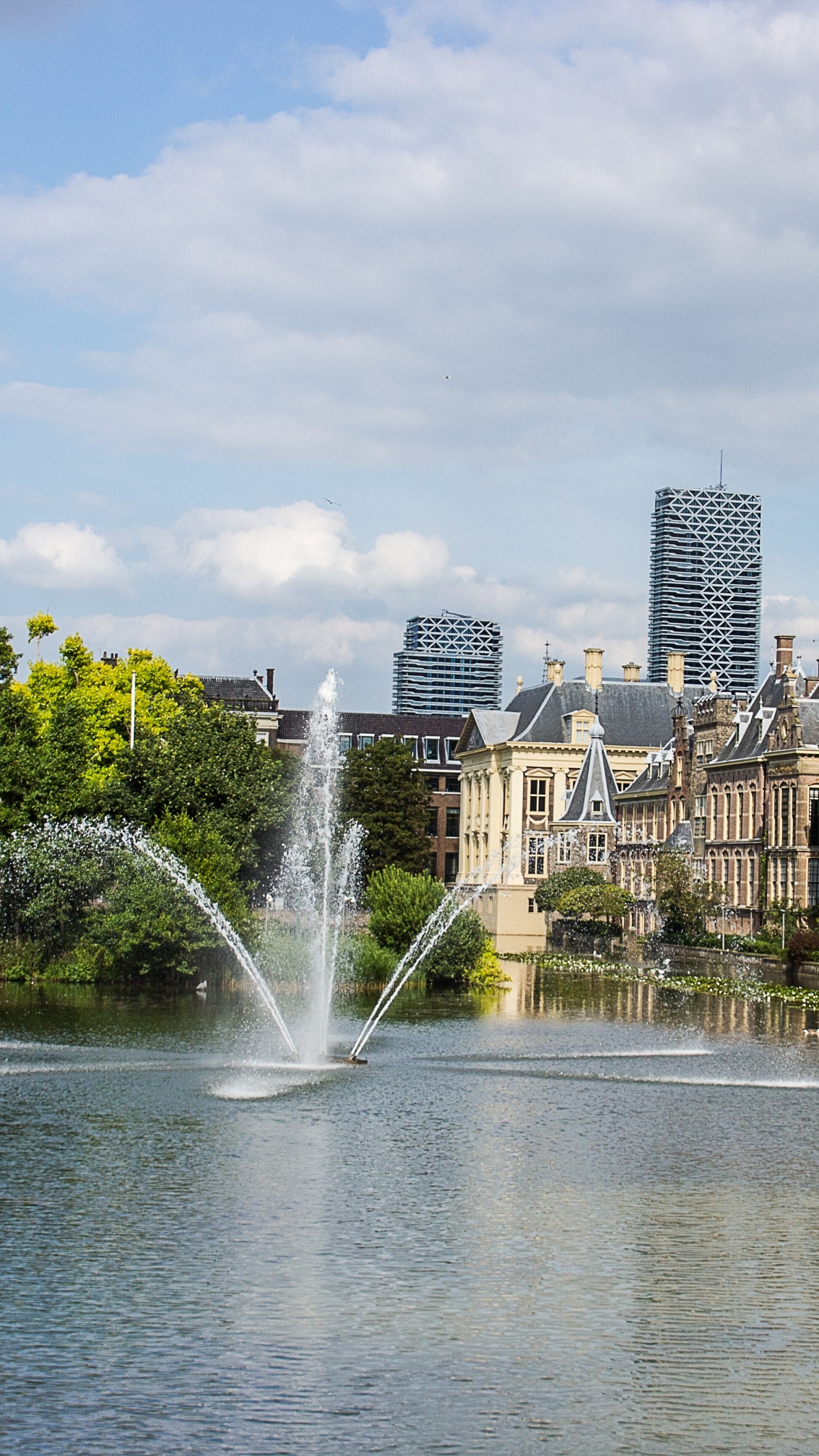 Water Fountain in The Middle of City Buildings During Daytime. Wallpaper in 1440x2560 Resolution