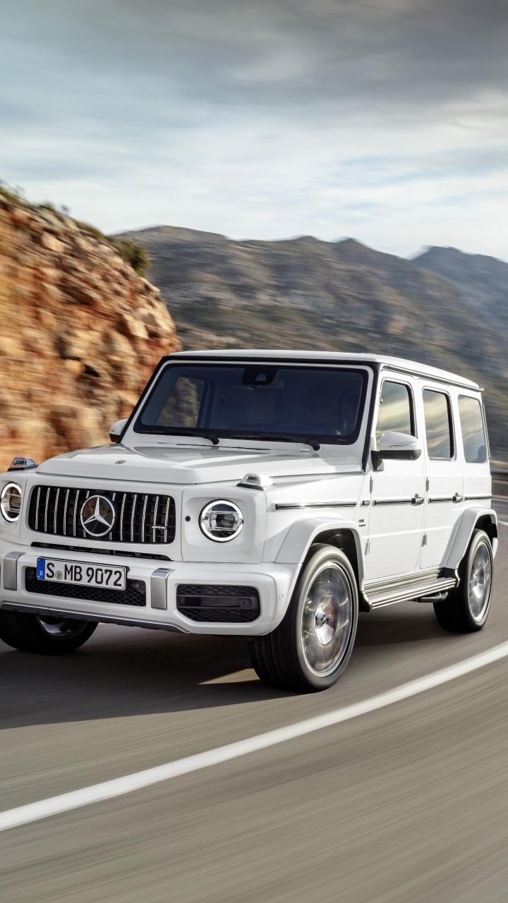 White Suv on Road During Daytime. Wallpaper in 720x1280 Resolution