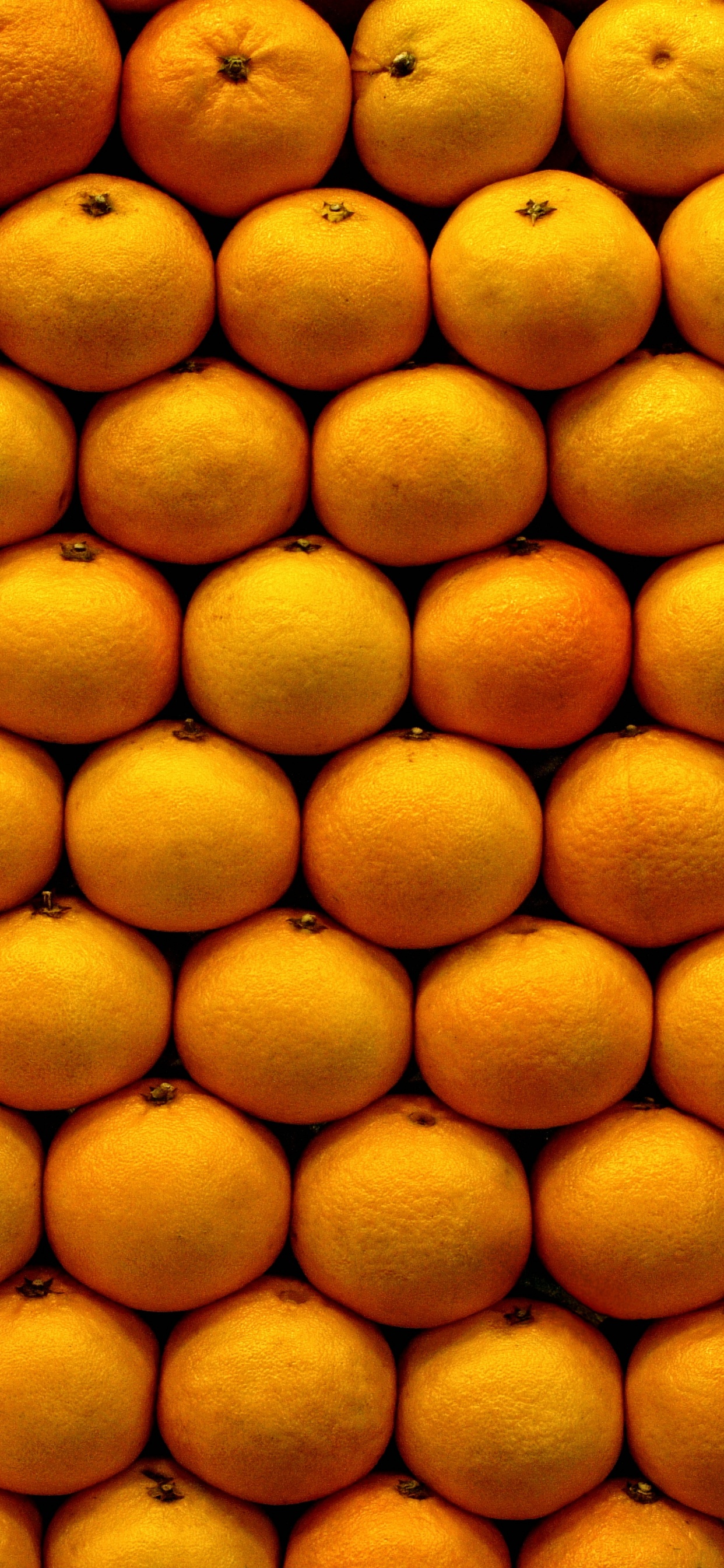 Frutos Redondos Amarillos Sobre Superficie Blanca. Wallpaper in 1242x2688 Resolution