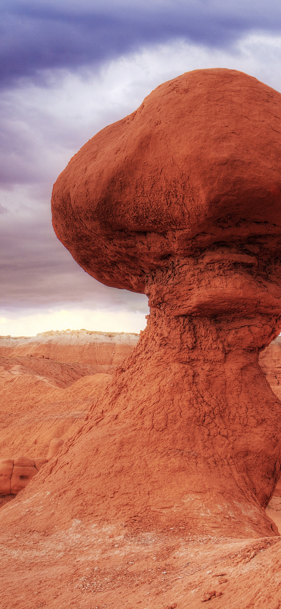 Brown Rock Formation Under Blue Sky. Wallpaper in 1125x2436 Resolution