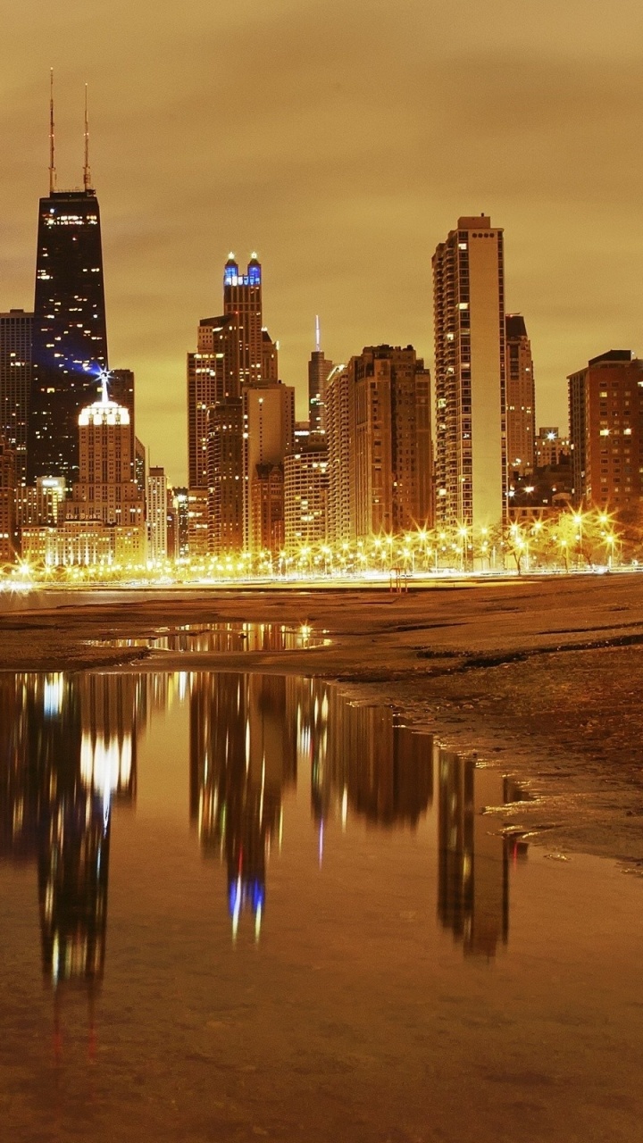 City Skyline Across Body of Water During Night Time. Wallpaper in 720x1280 Resolution