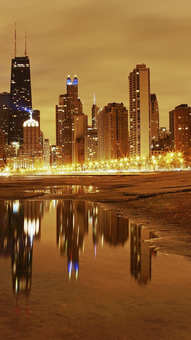 City Skyline Across Body of Water During Night Time. Wallpaper in 750x1334 Resolution