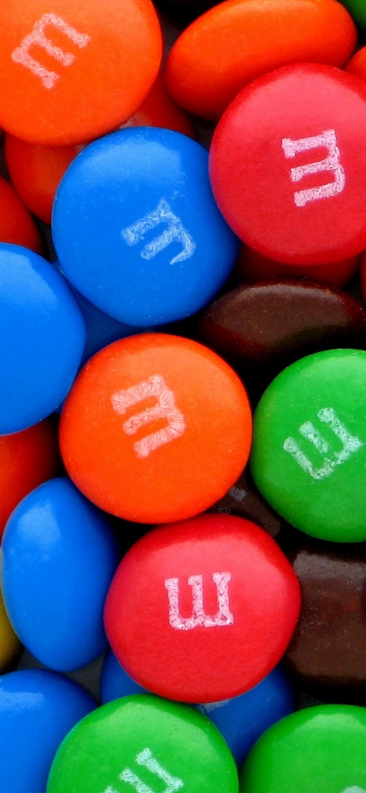 Blue Orange Green and Yellow m ms Chocolate Candies. Wallpaper in 1242x2688 Resolution