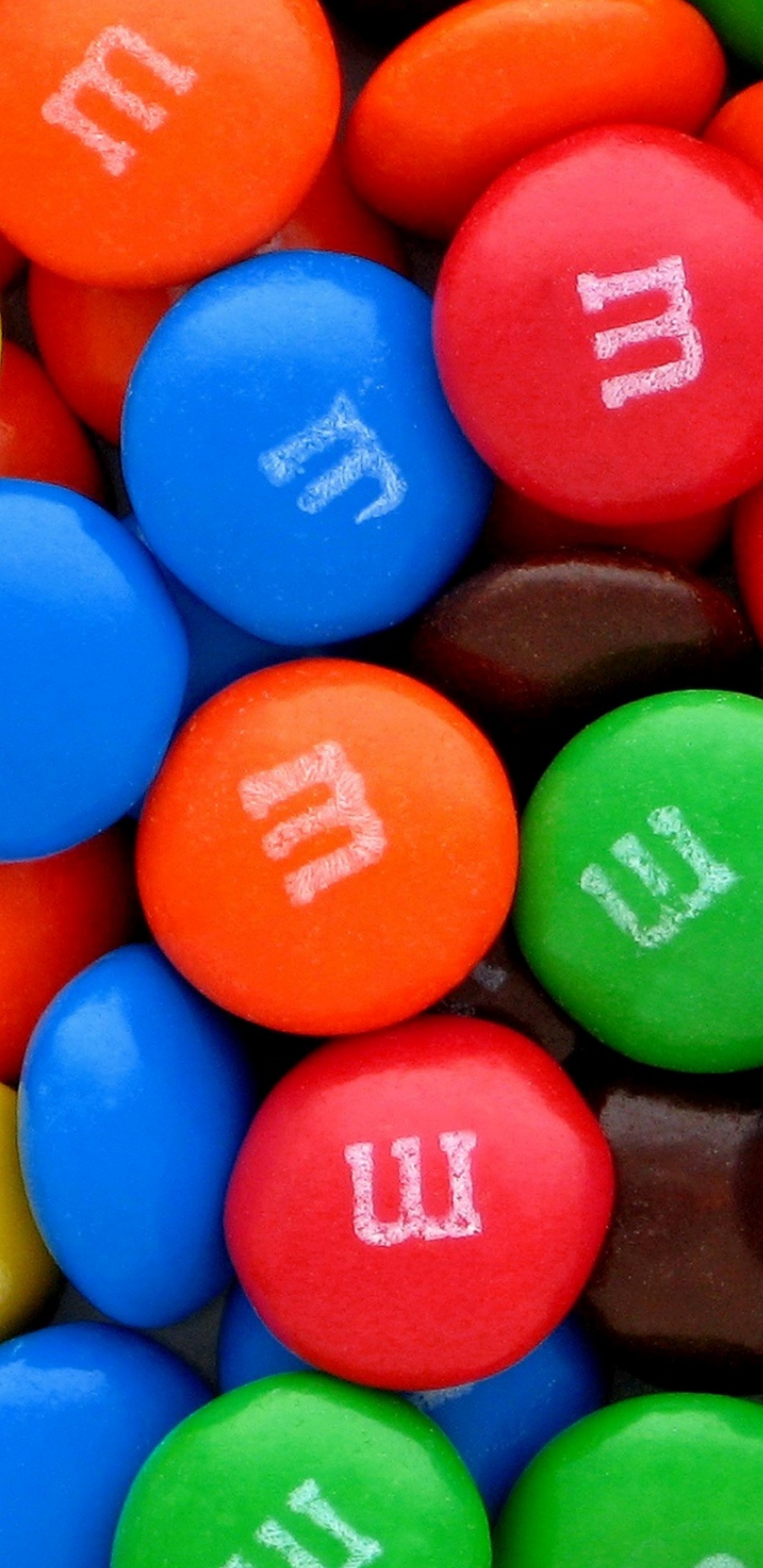 Blue Orange Green and Yellow m ms Chocolate Candies. Wallpaper in 1440x2960 Resolution