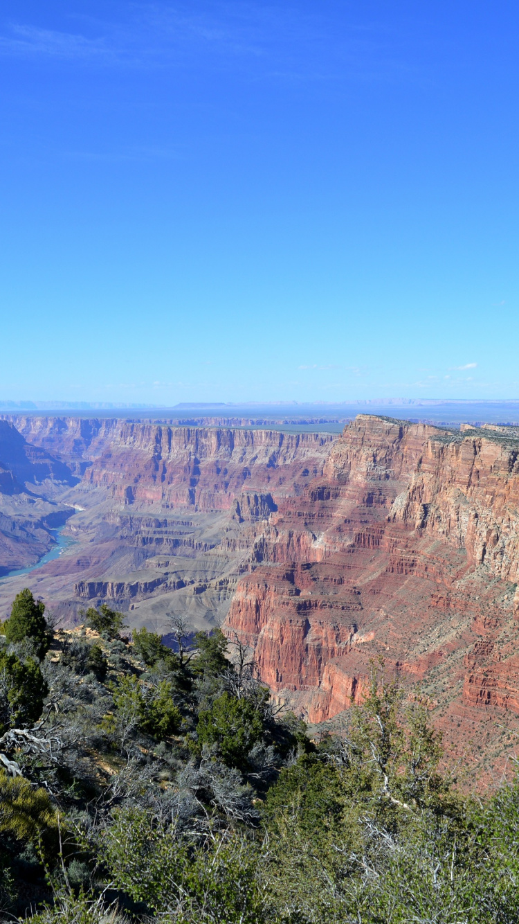 Brown Rocky Mountain Under Blue Sky During Daytime. Wallpaper in 750x1334 Resolution
