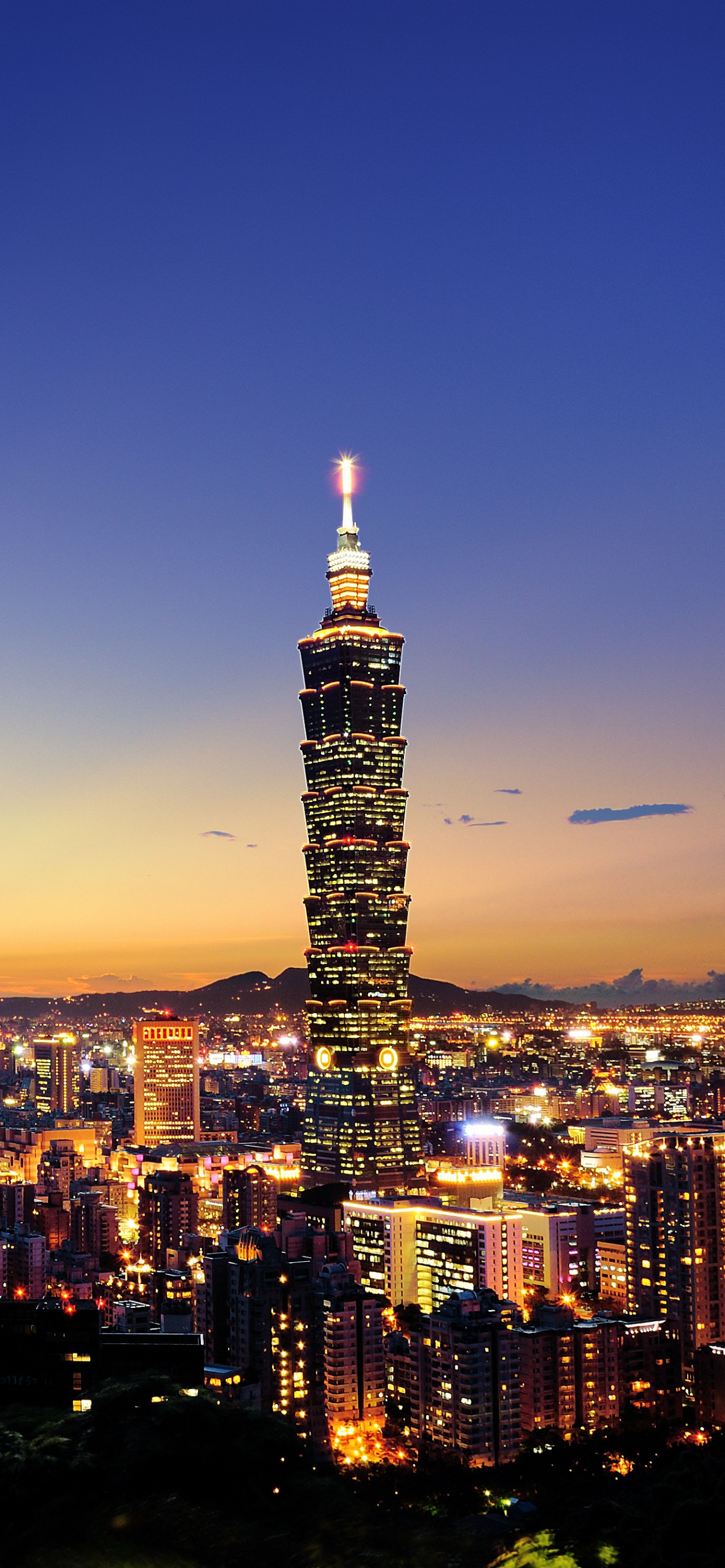 City With High Rise Buildings During Night Time. Wallpaper in 1242x2688 Resolution