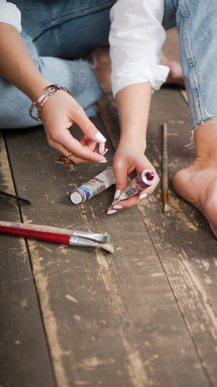 Person in Blue Denim Jeans Holding Red and Silver Click Pen. Wallpaper in 750x1334 Resolution