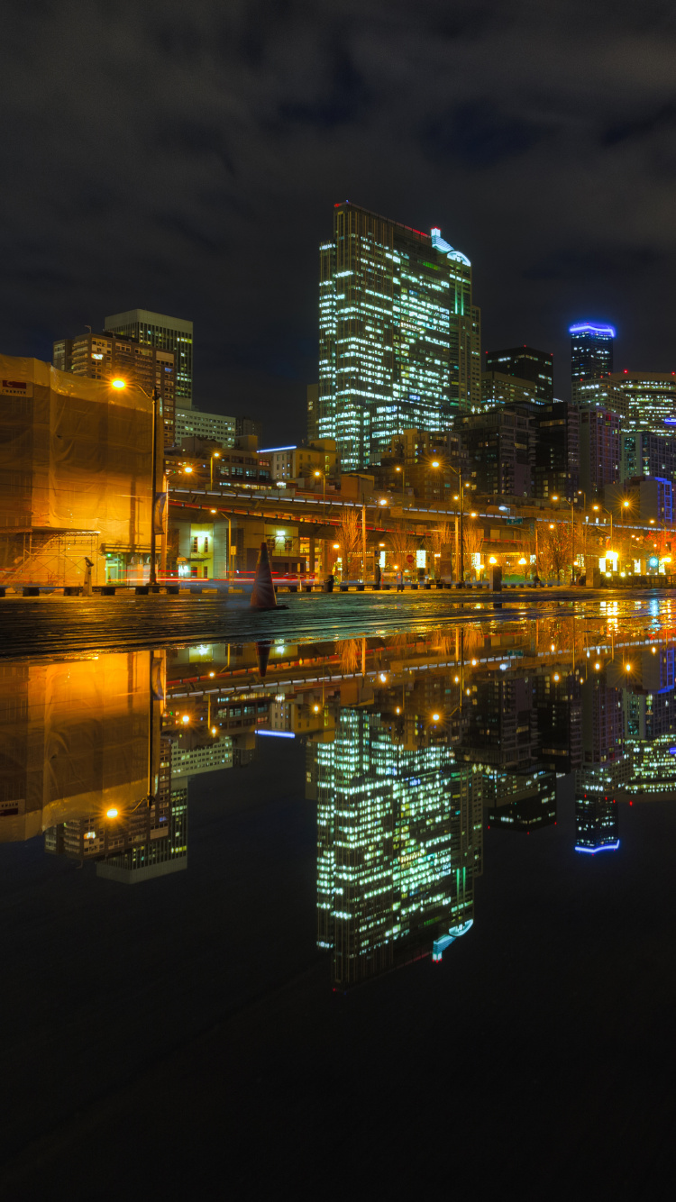 City Skyline Across Body of Water During Night Time. Wallpaper in 750x1334 Resolution
