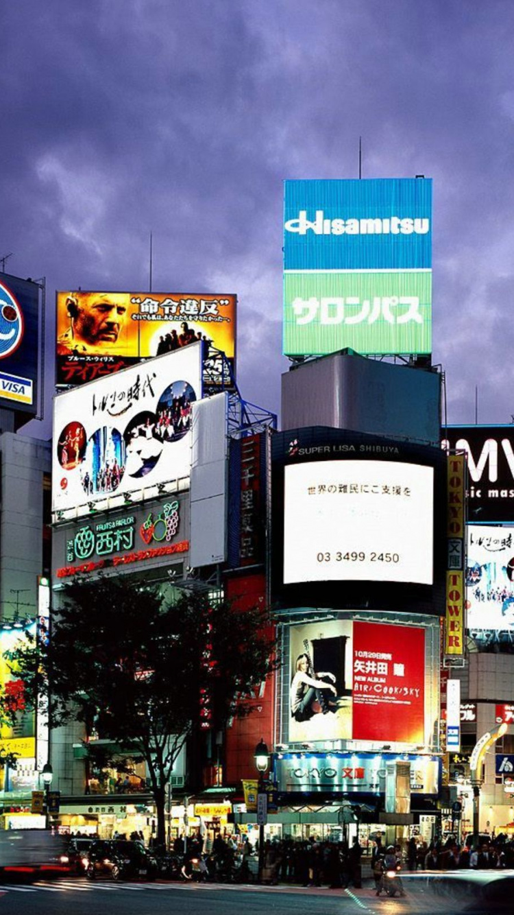 Rue de la Ville Avec Des Voitures Qui Passent Pendant la Nuit. Wallpaper in 750x1334 Resolution