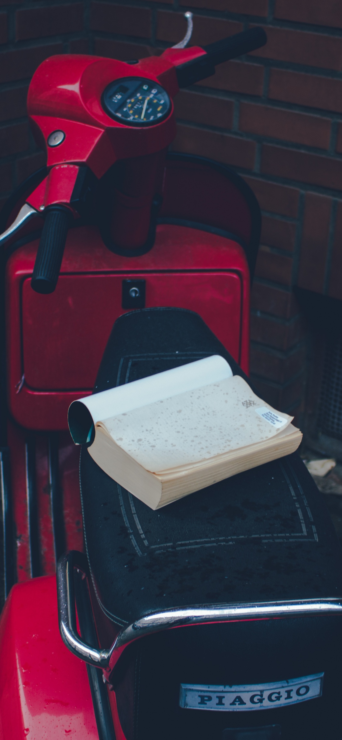 Red and Black Motor Scooter. Wallpaper in 1125x2436 Resolution