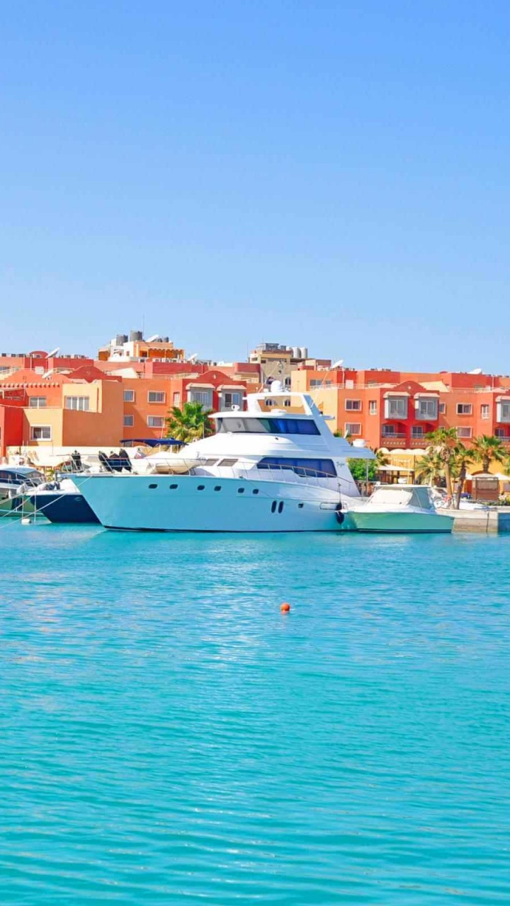 White Boat on Sea Near City Buildings During Daytime. Wallpaper in 720x1280 Resolution