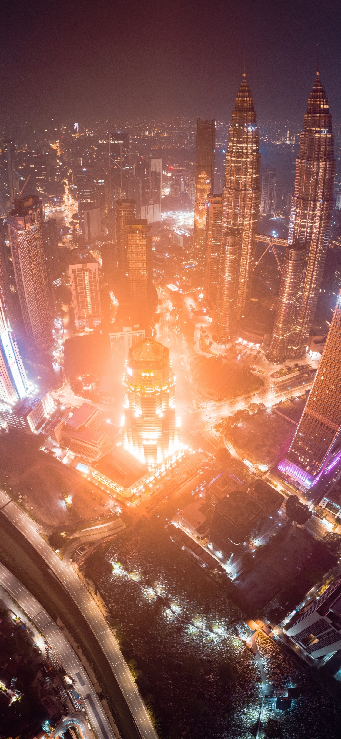 Aerial View of City Buildings During Night Time. Wallpaper in 1125x2436 Resolution