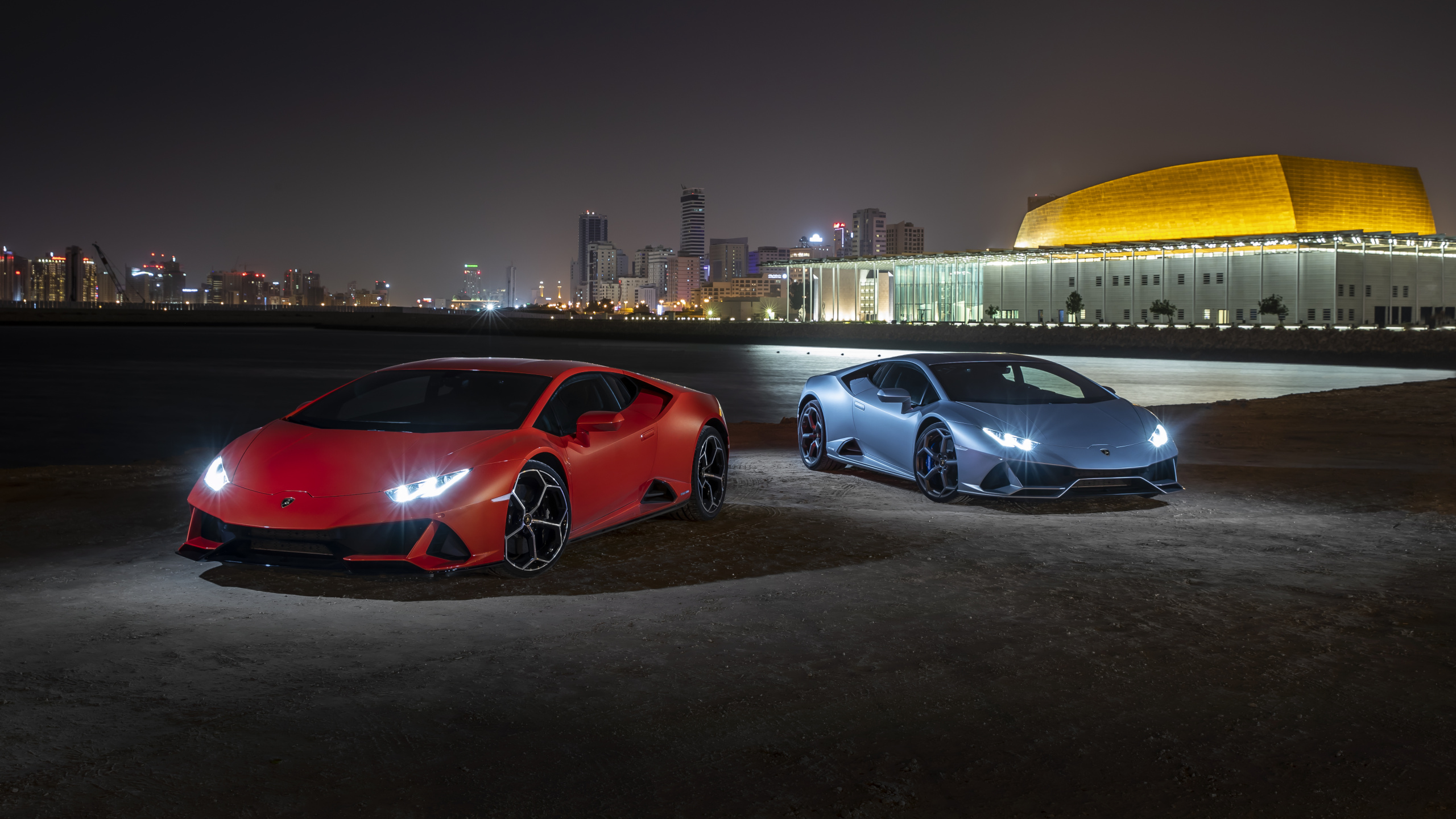 Red Coupe Parked on a Parking Lot. Wallpaper in 2560x1440 Resolution