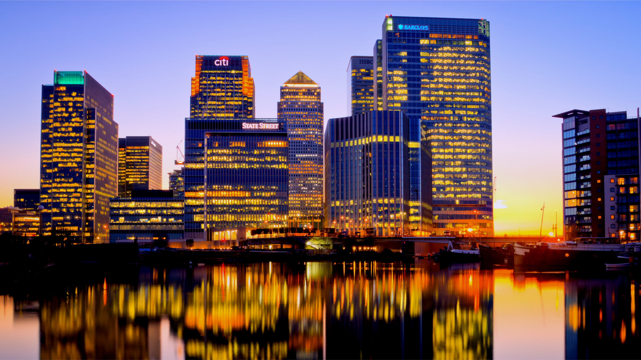 City Skyline Across Body of Water During Night Time. Wallpaper in 2560x1440 Resolution