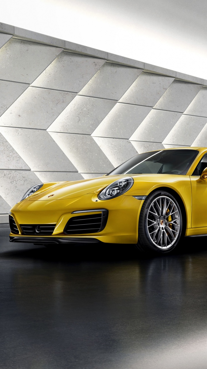 Gelber Porsche 911 Auf Grauem Betonpflaster Geparkt. Wallpaper in 720x1280 Resolution