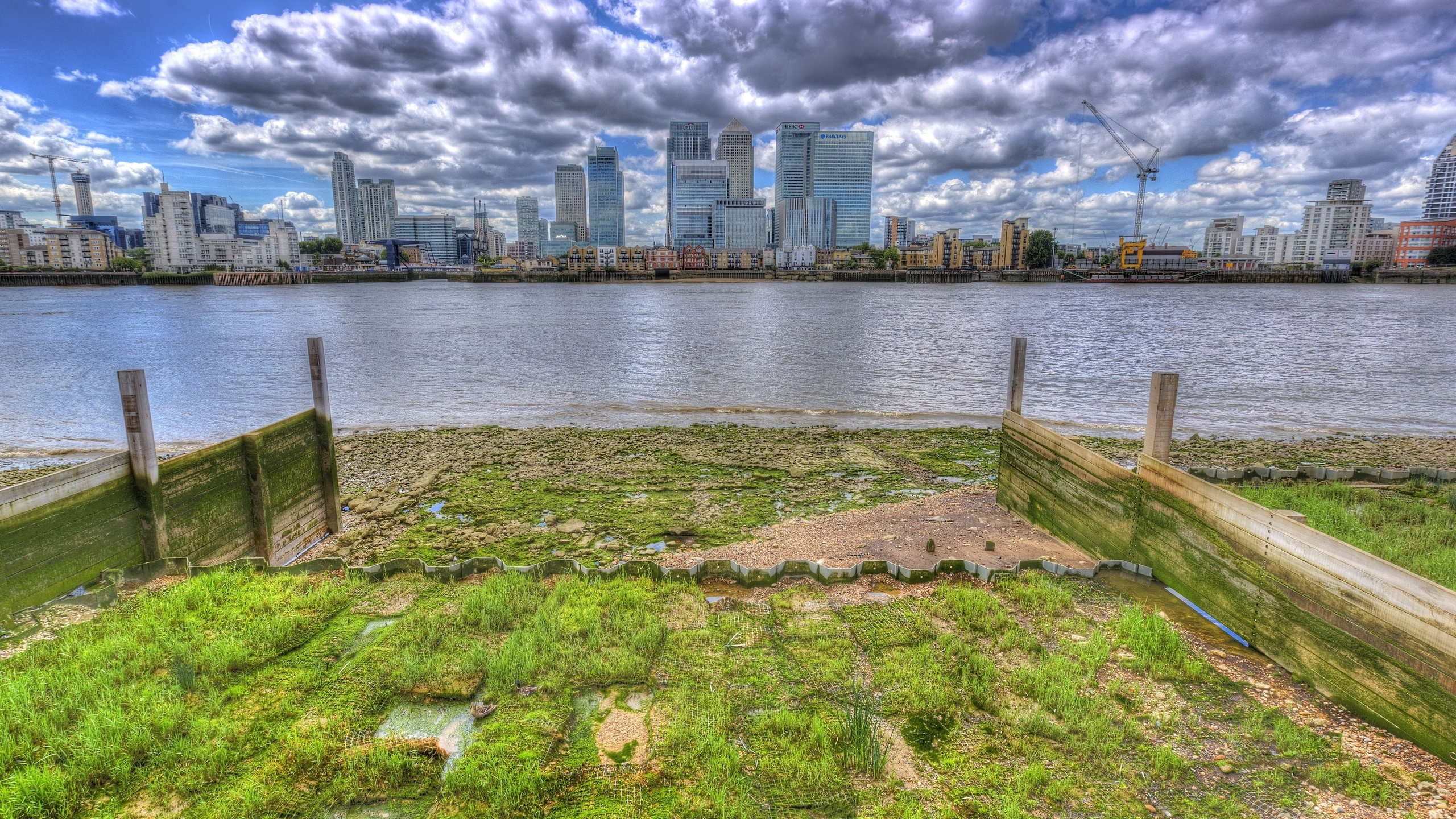 Body of Water Near City Buildings Under Cloudy Sky During Daytime. Wallpaper in 2560x1440 Resolution