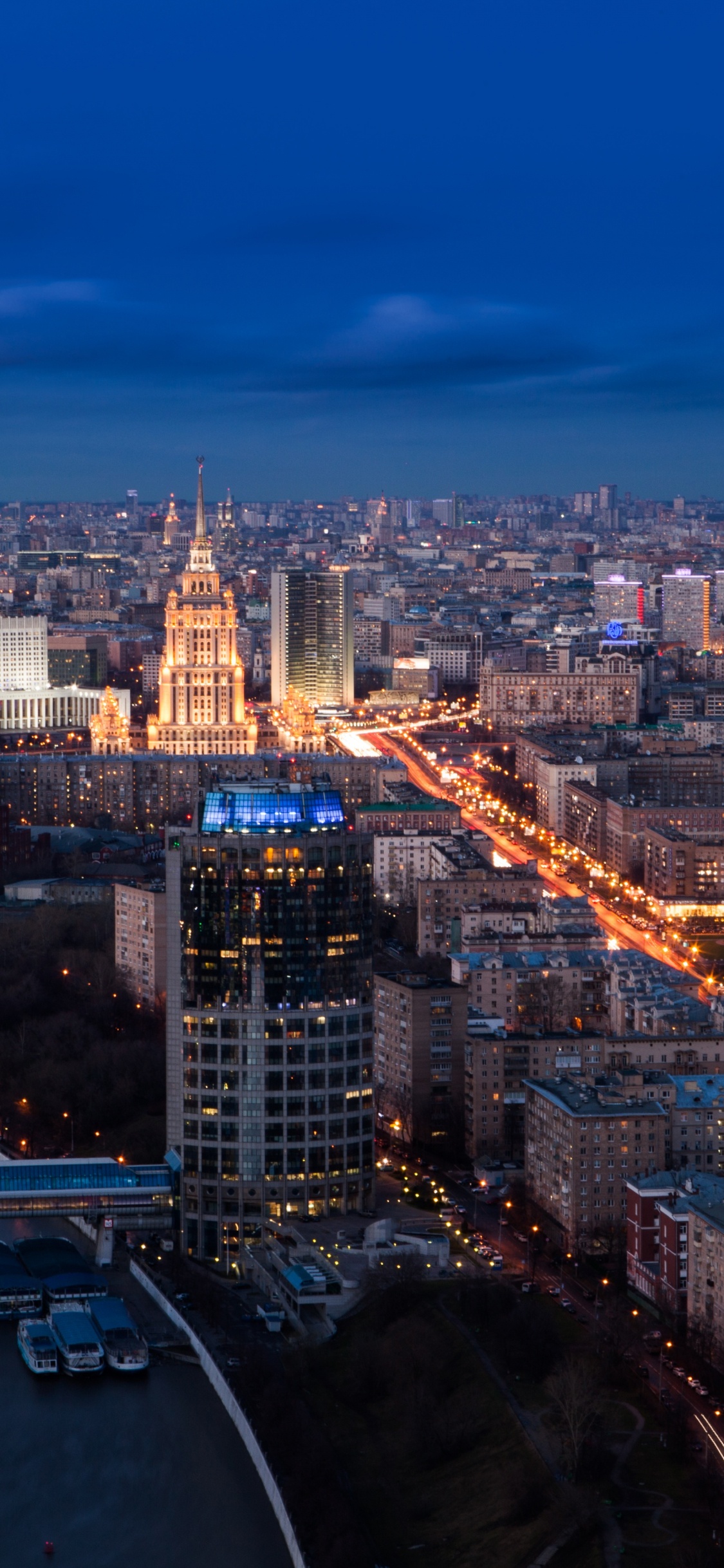 Aerial View of City Buildings During Night Time. Wallpaper in 1125x2436 Resolution