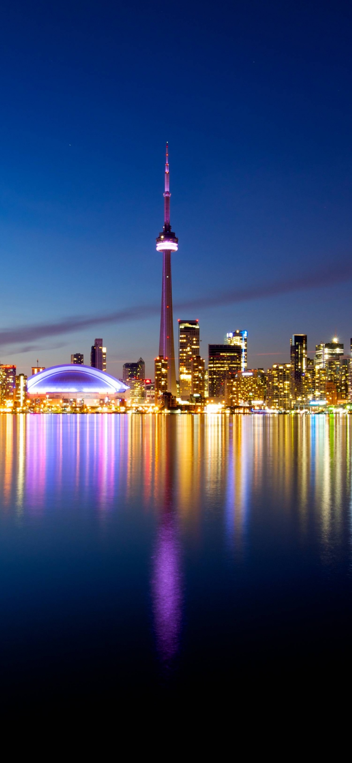 City Skyline During Night Time. Wallpaper in 1125x2436 Resolution