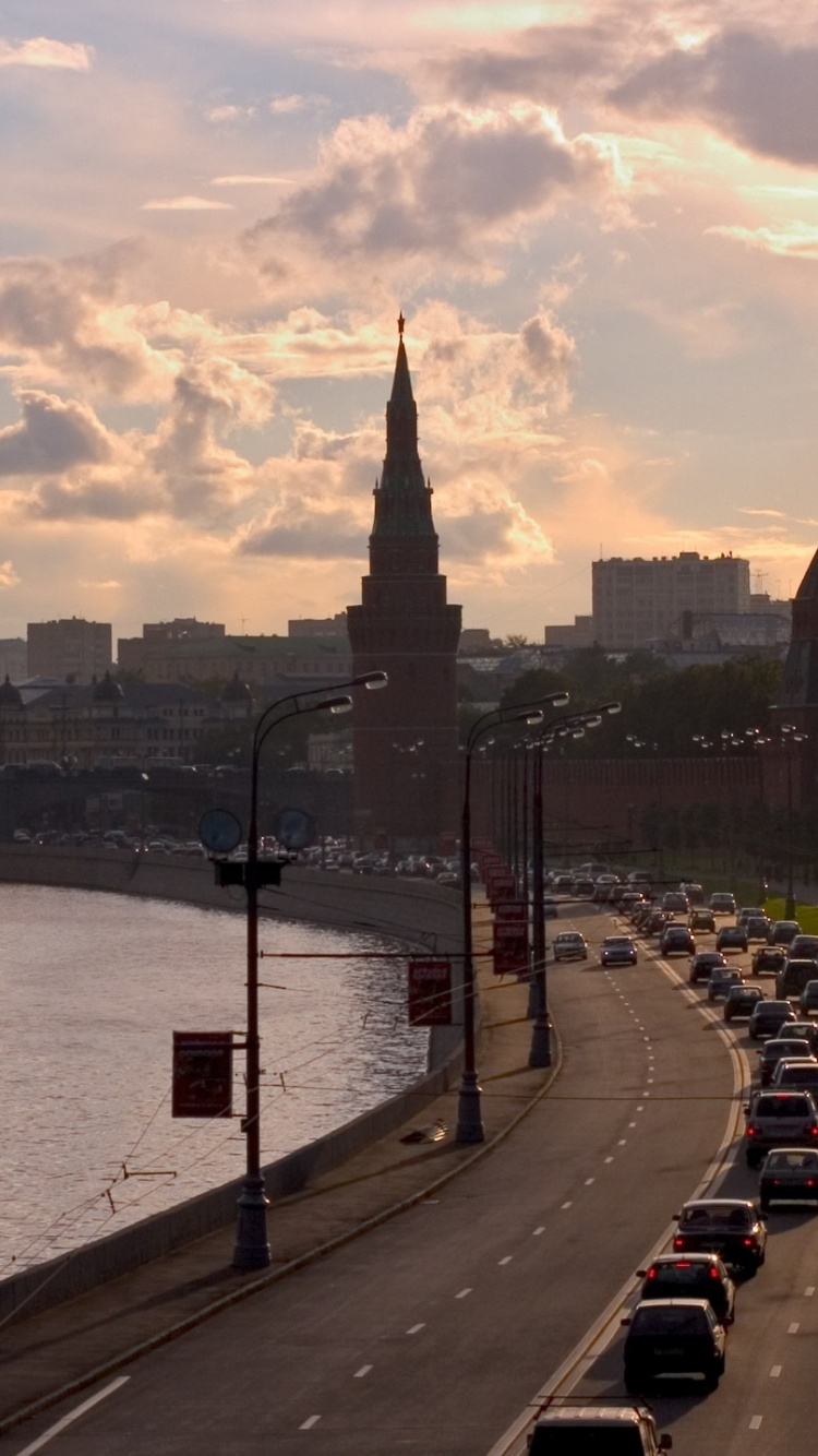 City Skyline Near Body of Water Under Cloudy Sky During Daytime. Wallpaper in 750x1334 Resolution