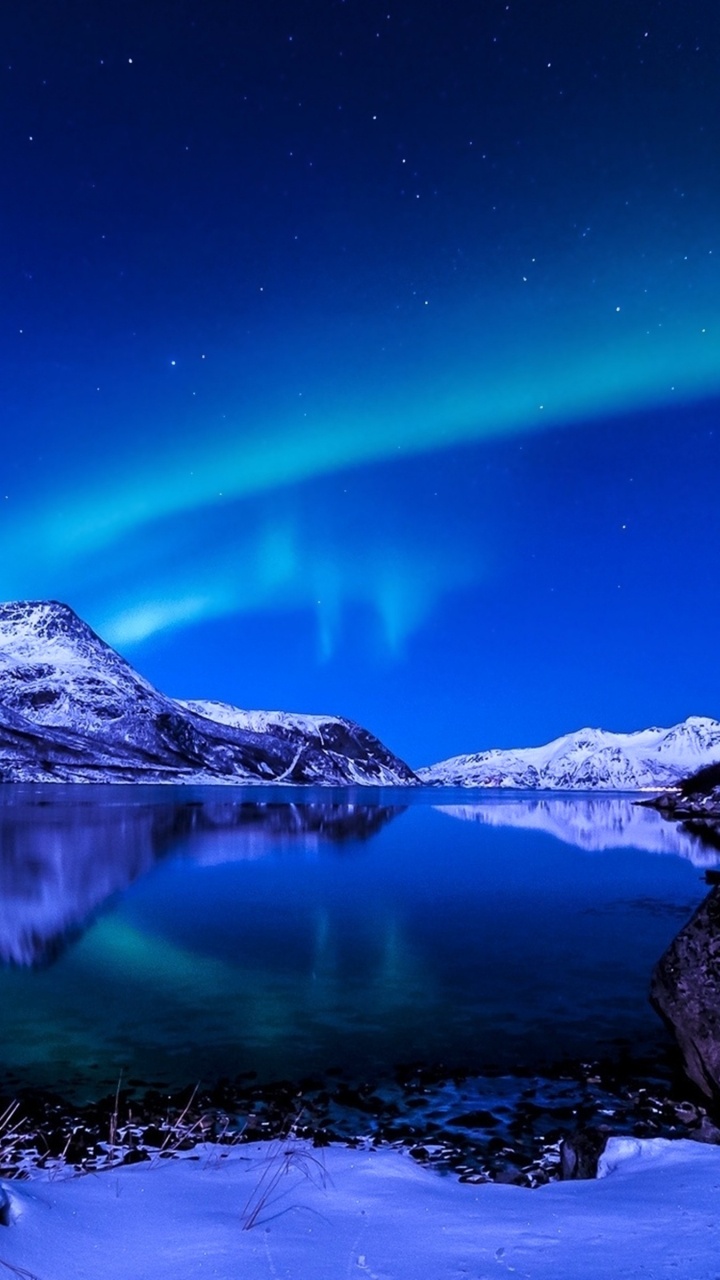 Snow Covered Mountain Near Body of Water During Night Time. Wallpaper in 720x1280 Resolution