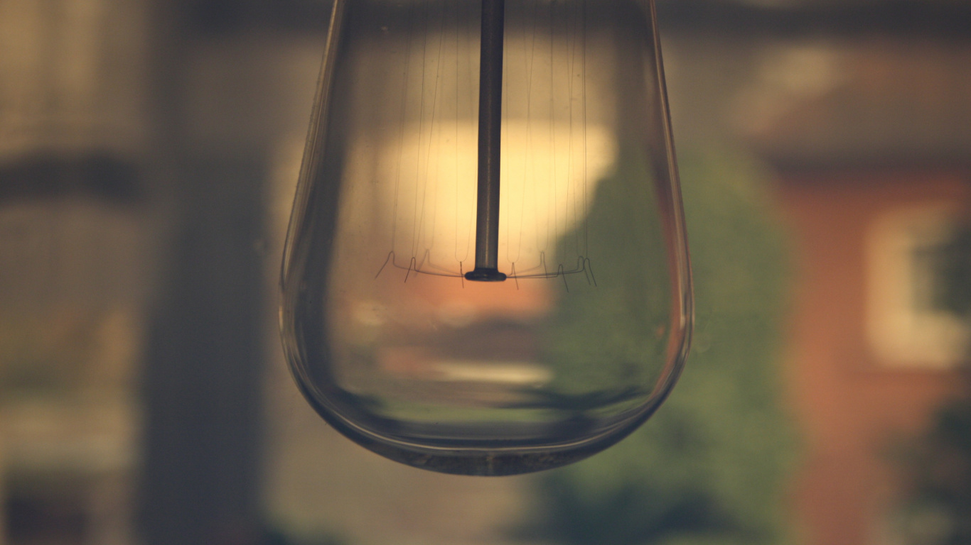 Clear Glass Light Bulb Turned on in Close up Photography. Wallpaper in 1366x768 Resolution