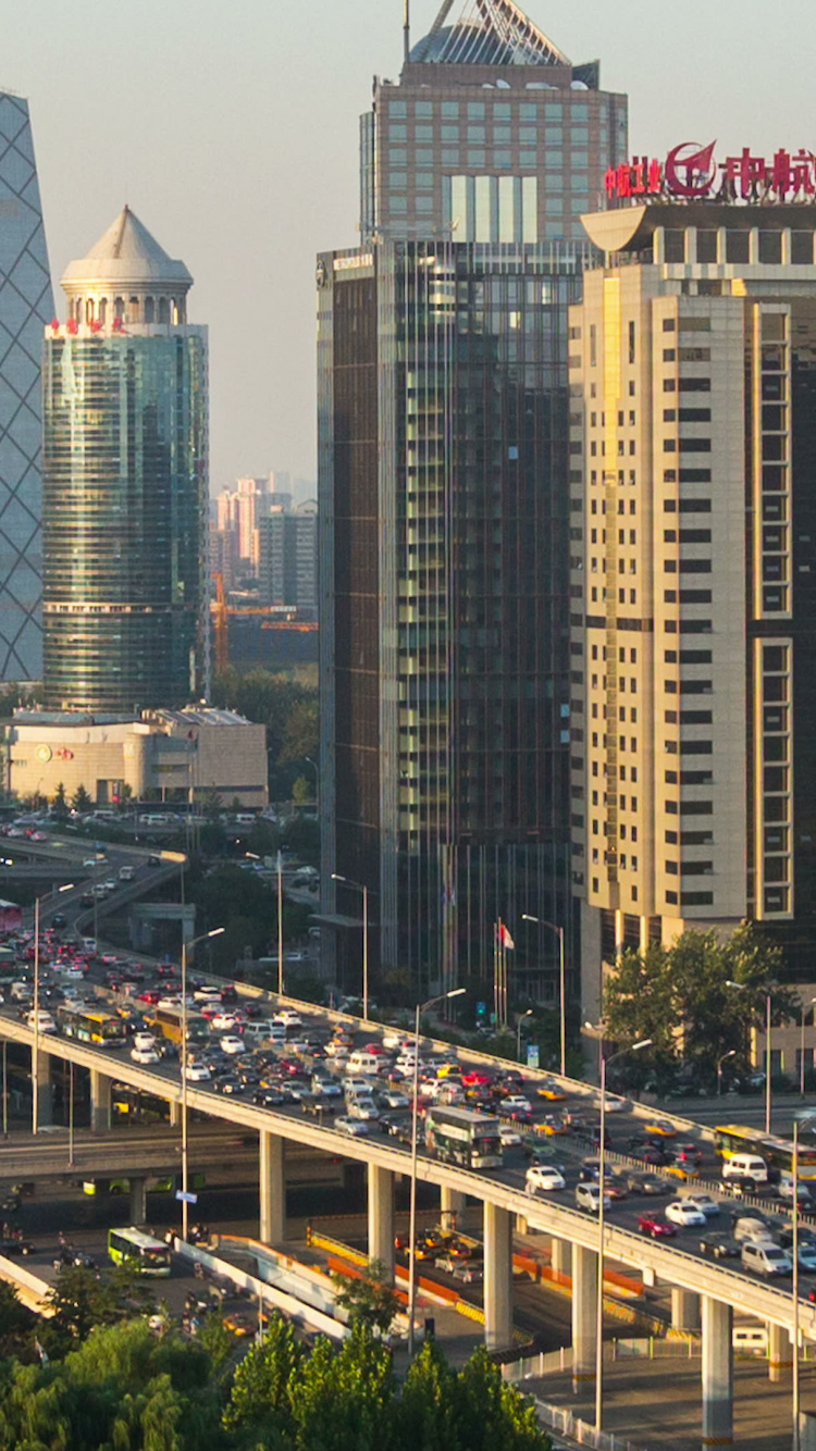 Cars on Road Near High Rise Buildings During Daytime. Wallpaper in 750x1334 Resolution