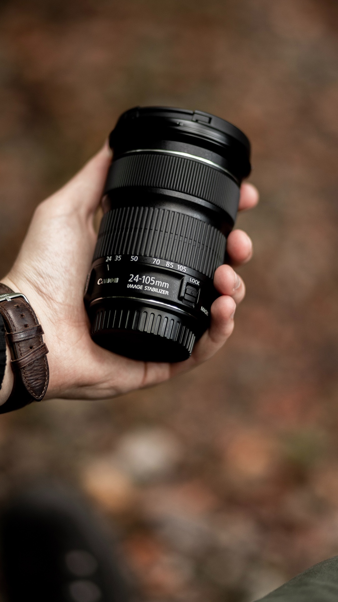 Person Holding Black Camera Lens. Wallpaper in 1080x1920 Resolution