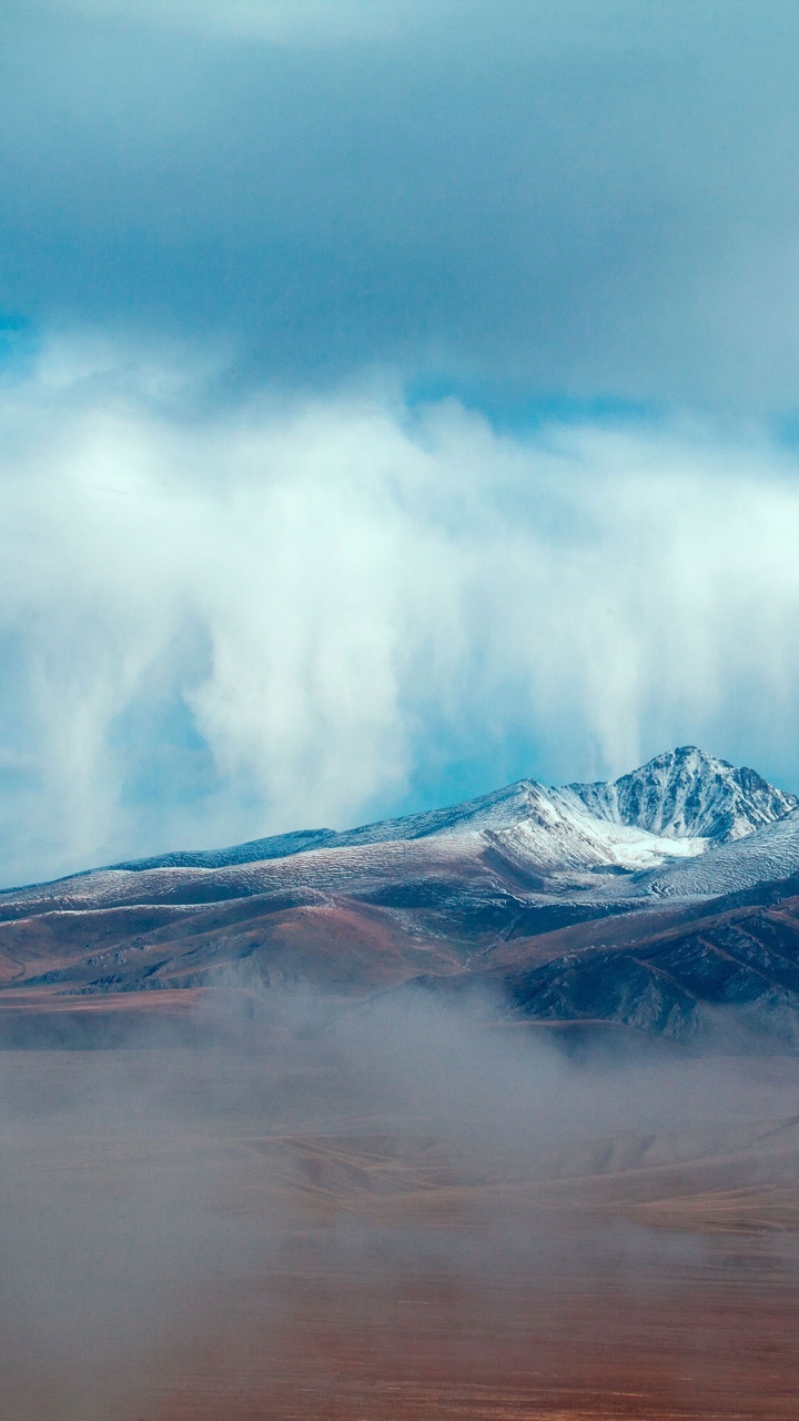 Snow Covered Mountain Under Cloudy Sky During Daytime. Wallpaper in 720x1280 Resolution