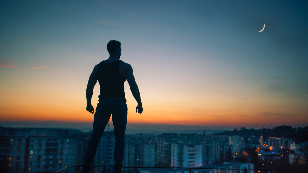 Man in Black Shirt and Pants Standing on Top of Building During Sunset. Wallpaper in 1280x720 Resolution