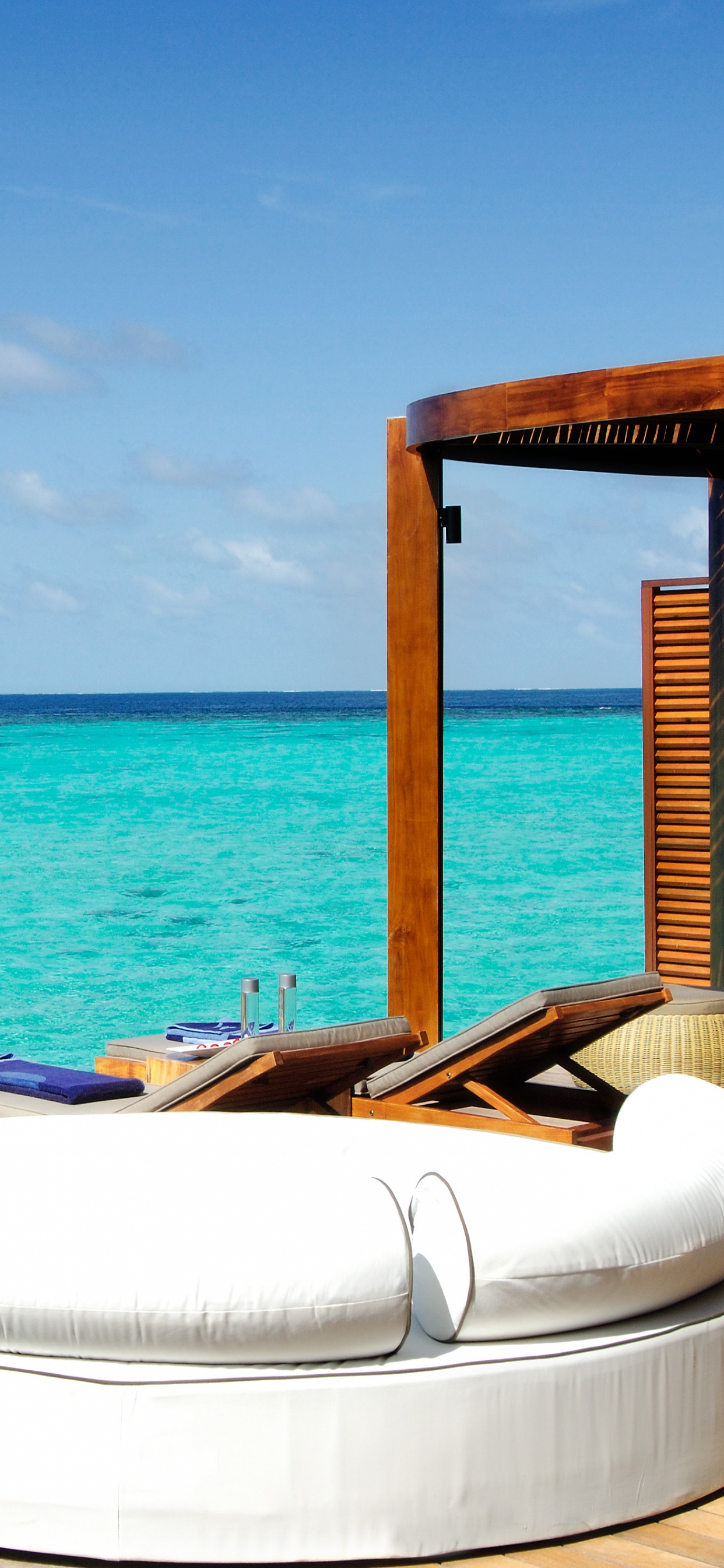 White and Brown Wooden Boat on Blue Sea Under Blue Sky During Daytime. Wallpaper in 1242x2688 Resolution