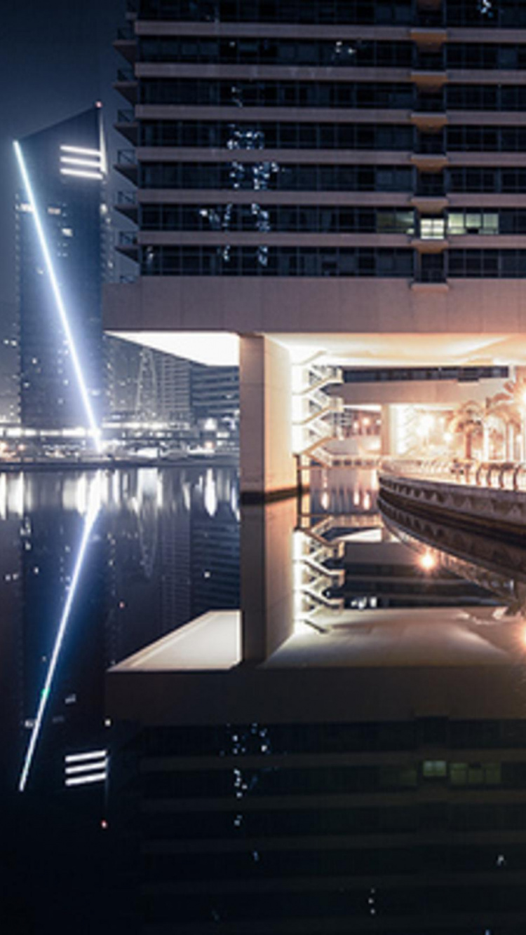 White Concrete Bridge Over River During Nighttime. Wallpaper in 750x1334 Resolution