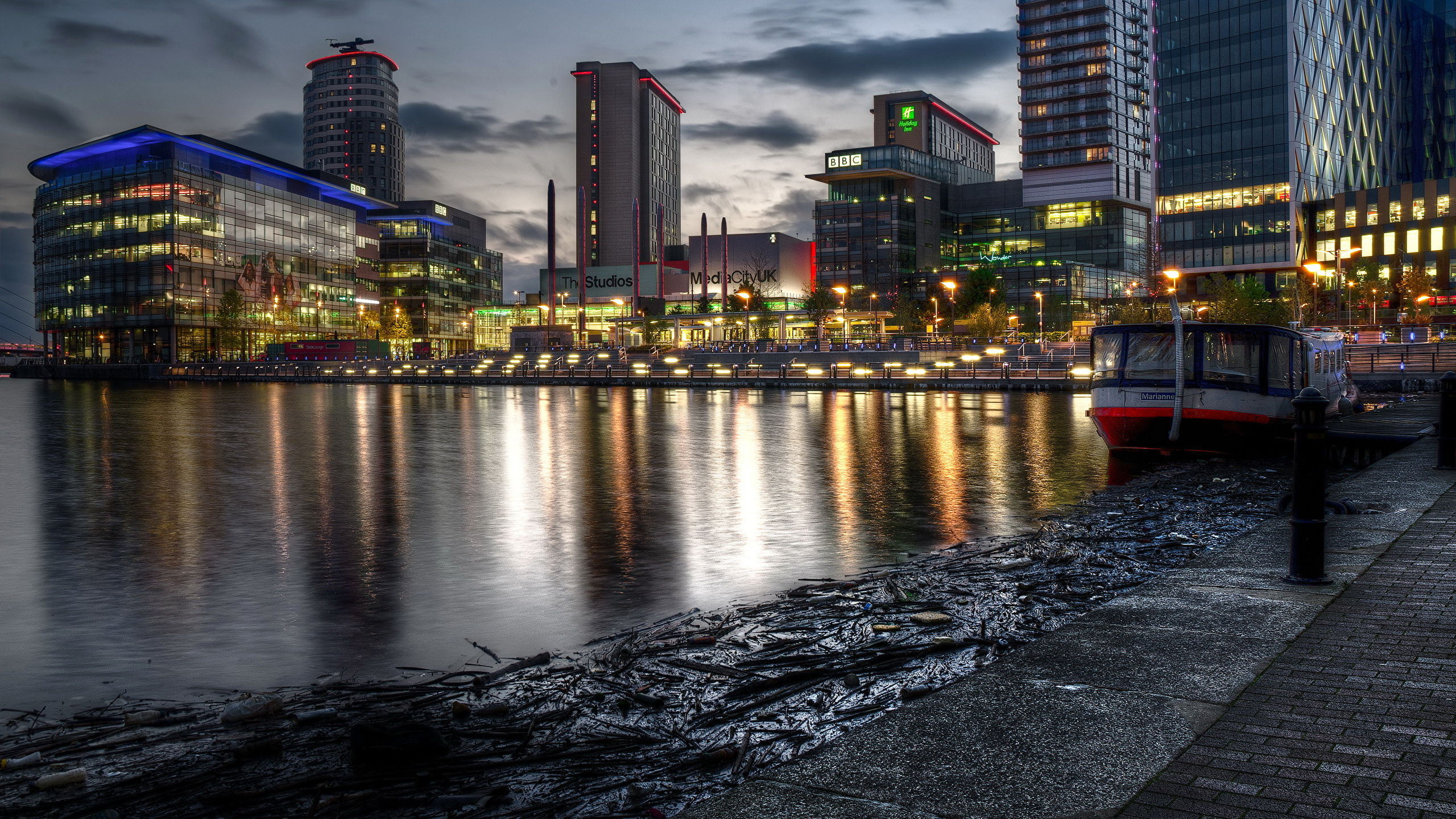 City Skyline Across Body of Water During Night Time. Wallpaper in 2560x1440 Resolution