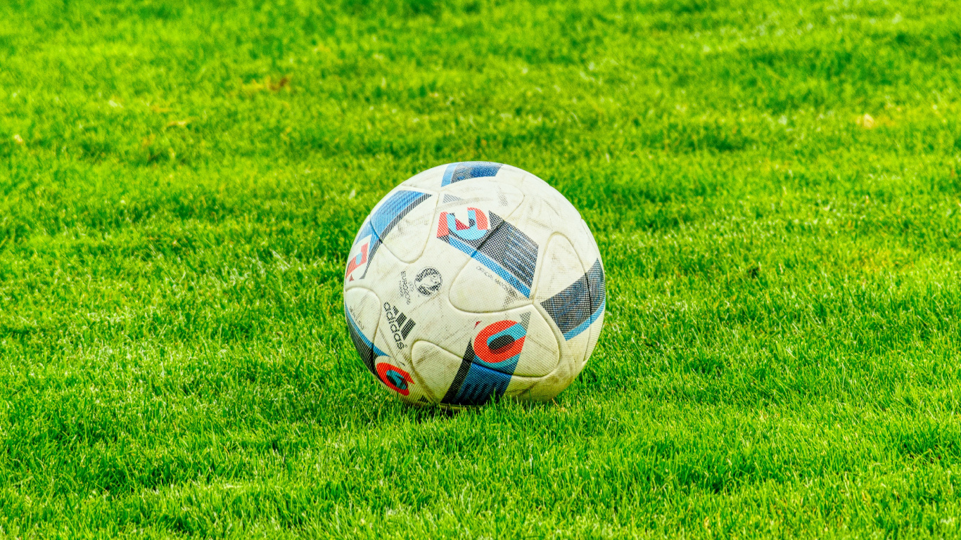 White Soccer Ball on Green Grass Field During Daytime. Wallpaper in 1366x768 Resolution