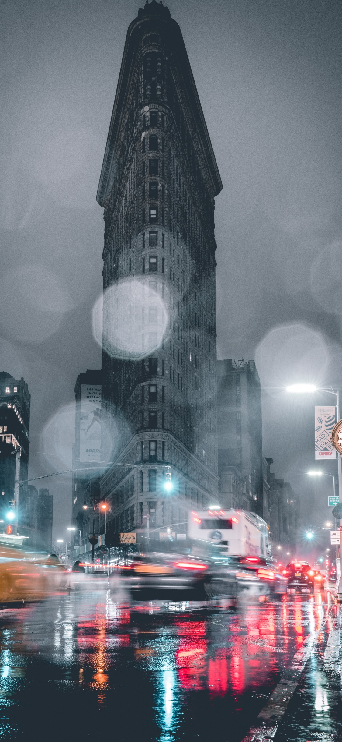 Cars on Road Near High Rise Buildings During Night Time. Wallpaper in 1125x2436 Resolution