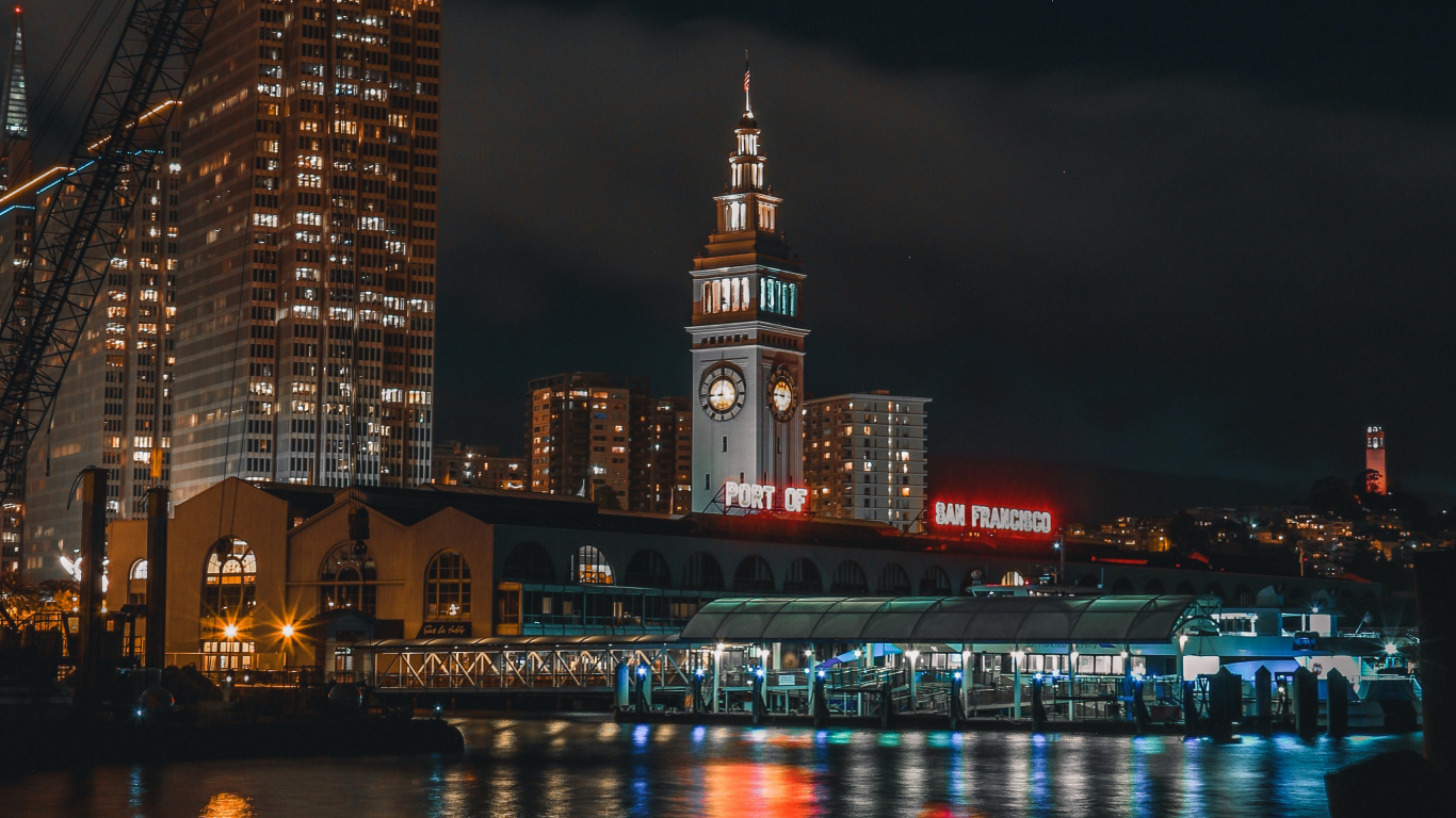 Lighted City Buildings Near Body of Water During Night Time. Wallpaper in 1366x768 Resolution