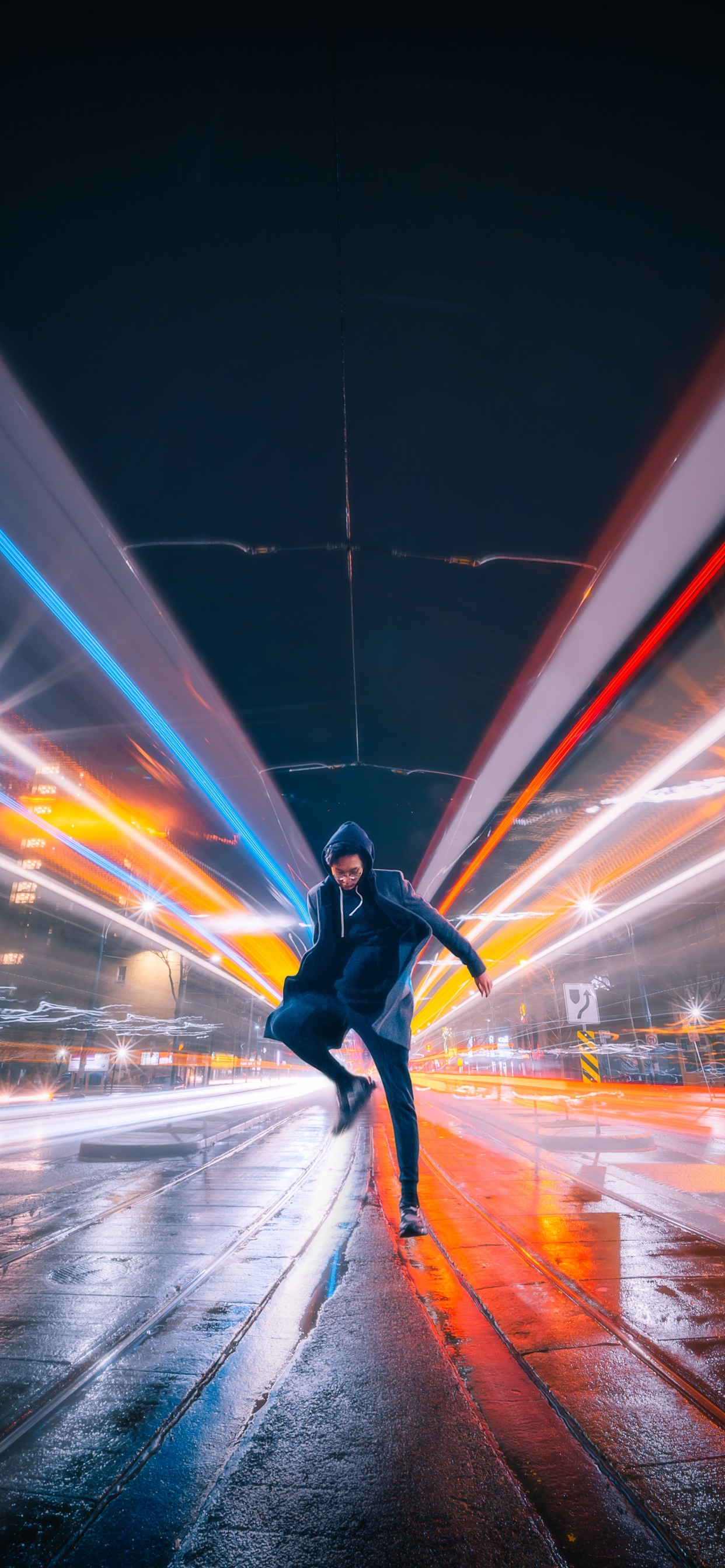 Man in Black Jacket and Black Pants Walking on Street During Night Time. Wallpaper in 1242x2688 Resolution