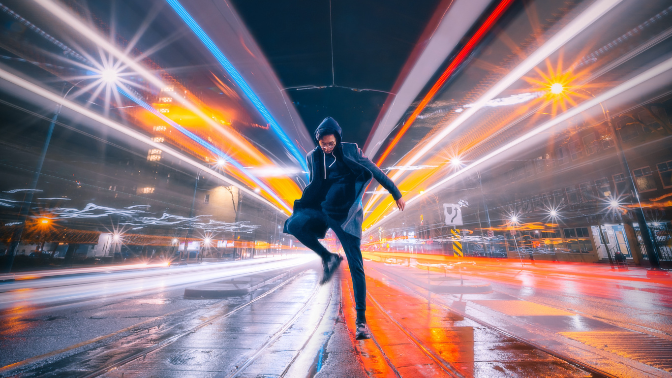 Man in Black Jacket and Black Pants Walking on Street During Night Time. Wallpaper in 1366x768 Resolution