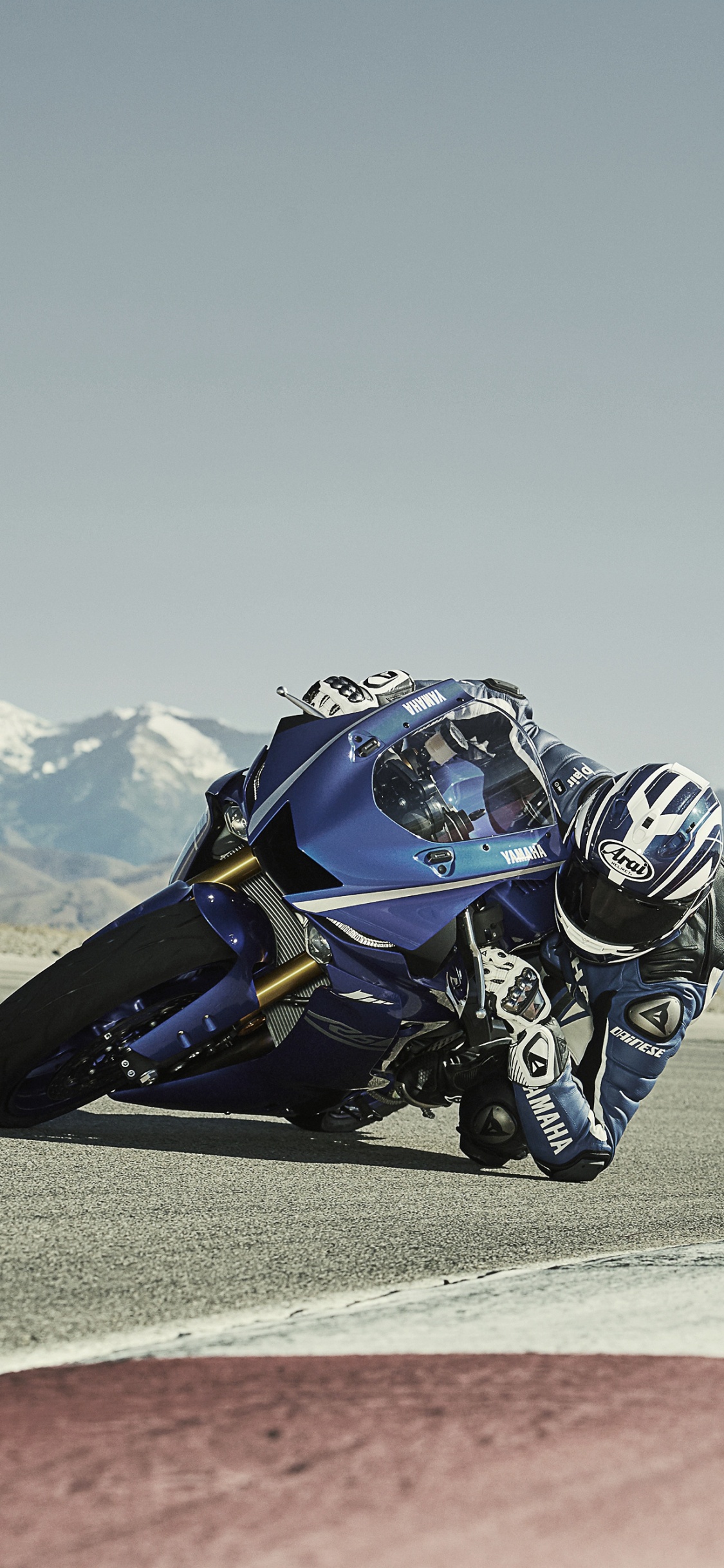 Man Riding Blue and White Sports Bike on Brown Field During Daytime. Wallpaper in 1125x2436 Resolution